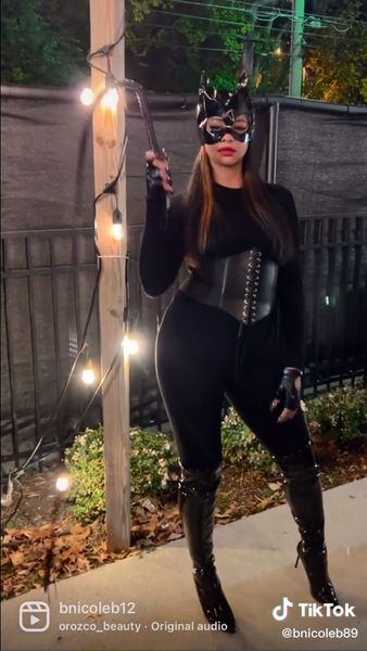 A woman dressed in a Sexy Catwoman Halloween costume.