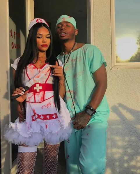 A man and woman dressed in sexy nurse and sexy doctor Halloween costumes.