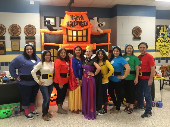 A group of co-workers dressed in a Snow White and the Seven Dwarfs group Halloween costume.