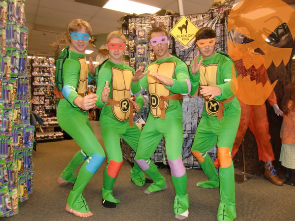A group of men dressed in Halloween costumes as Donatello, Raphael, Michaelangelo, and Leonardo from Teenage Mutant Ninja Turtles.