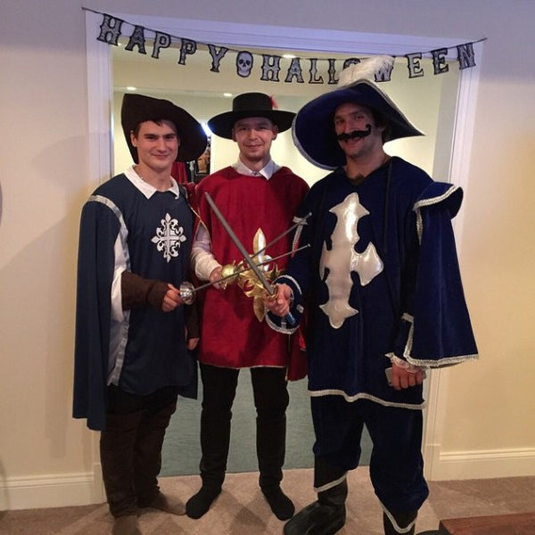 Three men dressed in a Three Musketeers group Halloween Costume.