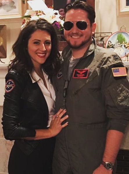 A couple wearing coordinating Top Gun Halloween costumes.