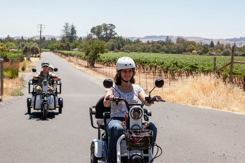 People riding hte PushPak electric scooter