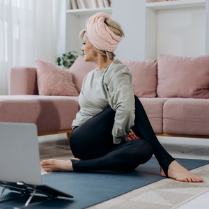 Elderly Women Doing Exercise In Living Room