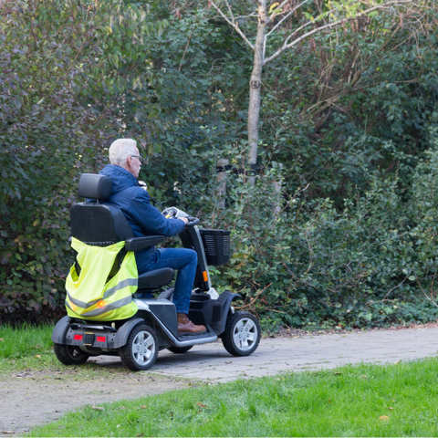Person Driving Mobility Scooter