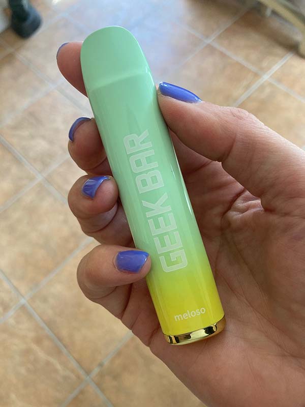 A Geek Bar Meloso 600 disposable vape held in a hand