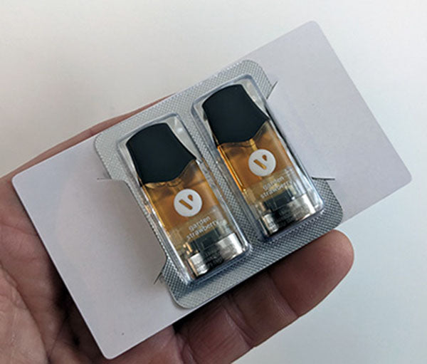 A pack of 2 Vuse Pro prefilled pods held in a hand