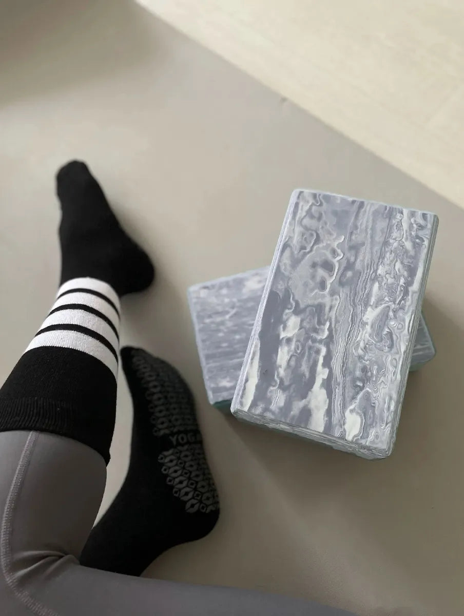 User holding grey marble EVA yoga block, Sportive Lives Yoga Block CLOUD customer review for indoor yoga sessions
