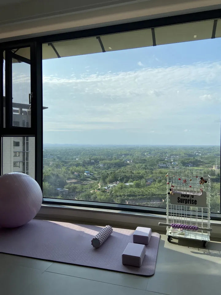 Yoga block set up in a modern, spacious workout space with a scenic view of nature, showcasing its use in yoga routines.