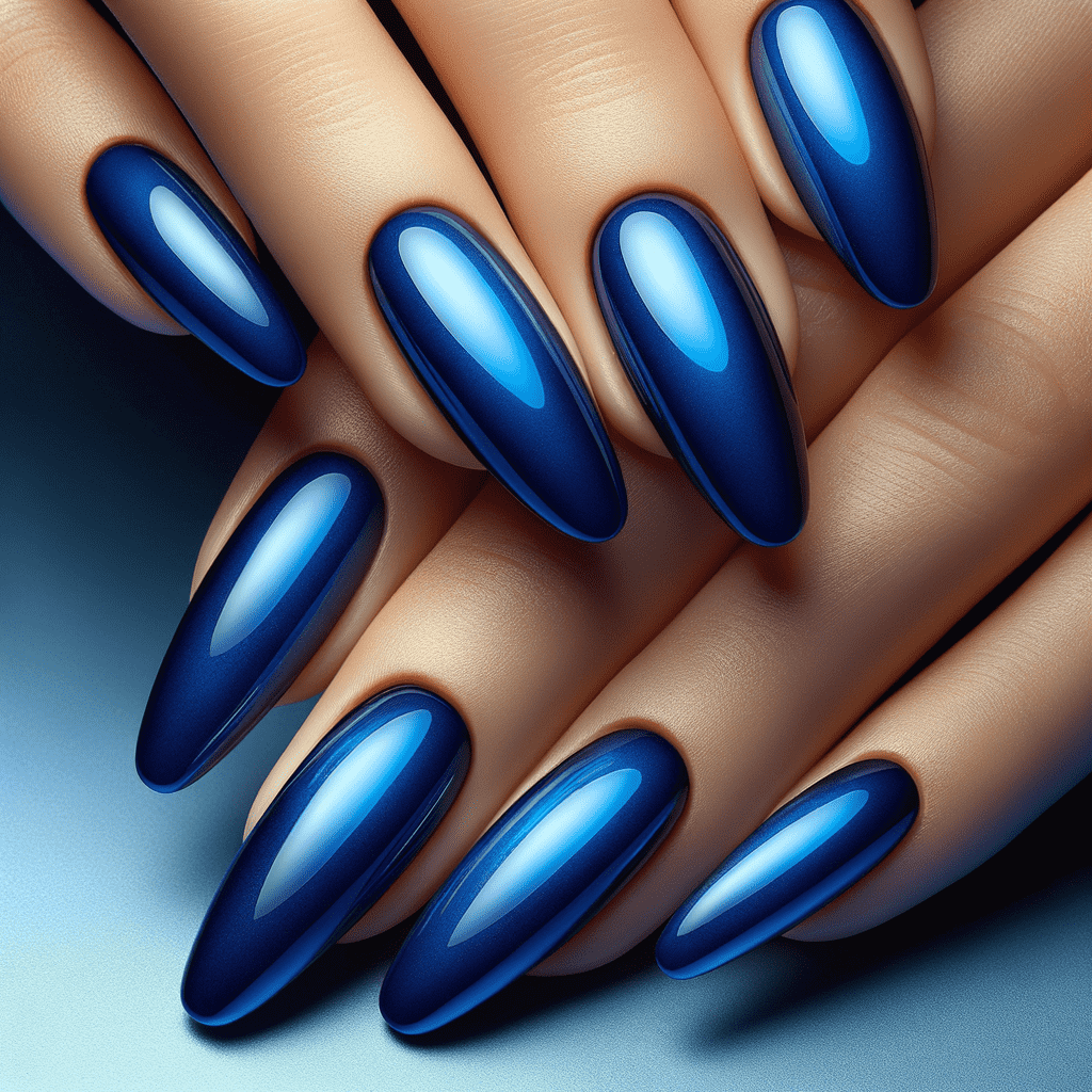 Alt text: A close-up of hands with long, stiletto-shaped nails painted in a glossy, ombre blue design that transitions from a deep navy at the tips to a bright sky blue at the bases.