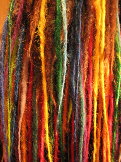 fall of brightly coloured synthetic dreadlocks in orange yellow blue and green