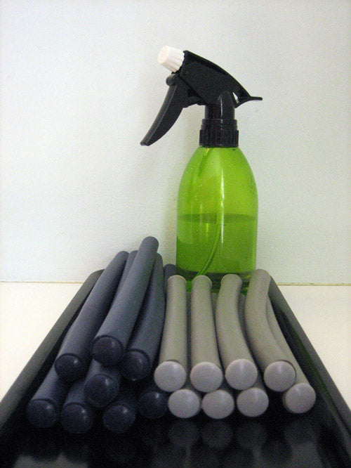 tray of foam curlers and spray bottle 