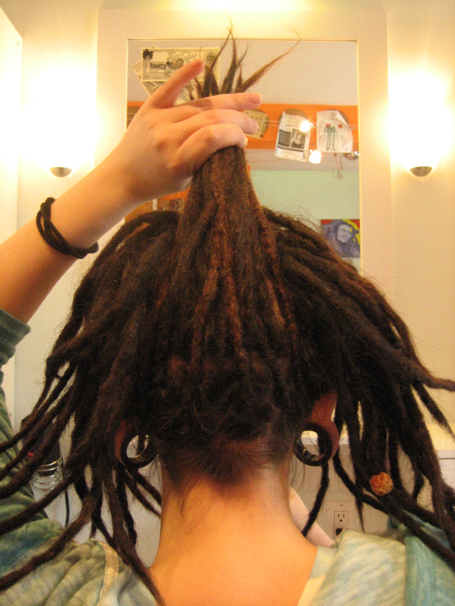 knotted updo first step - a handful of dreads drawn up from the nape of the neck