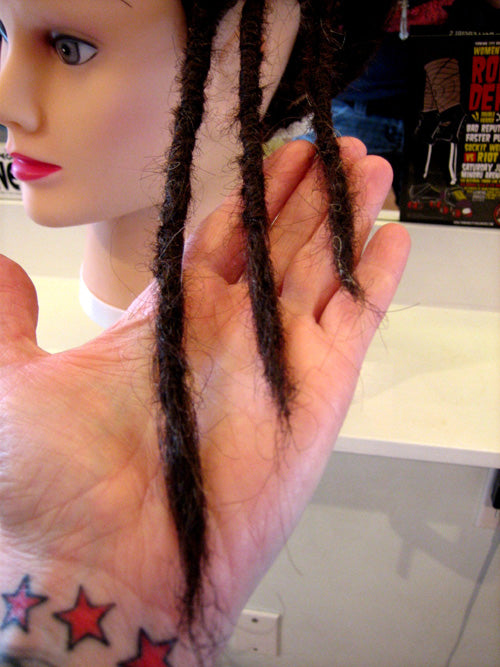 hand holding ends of newly maintained dreadlocks