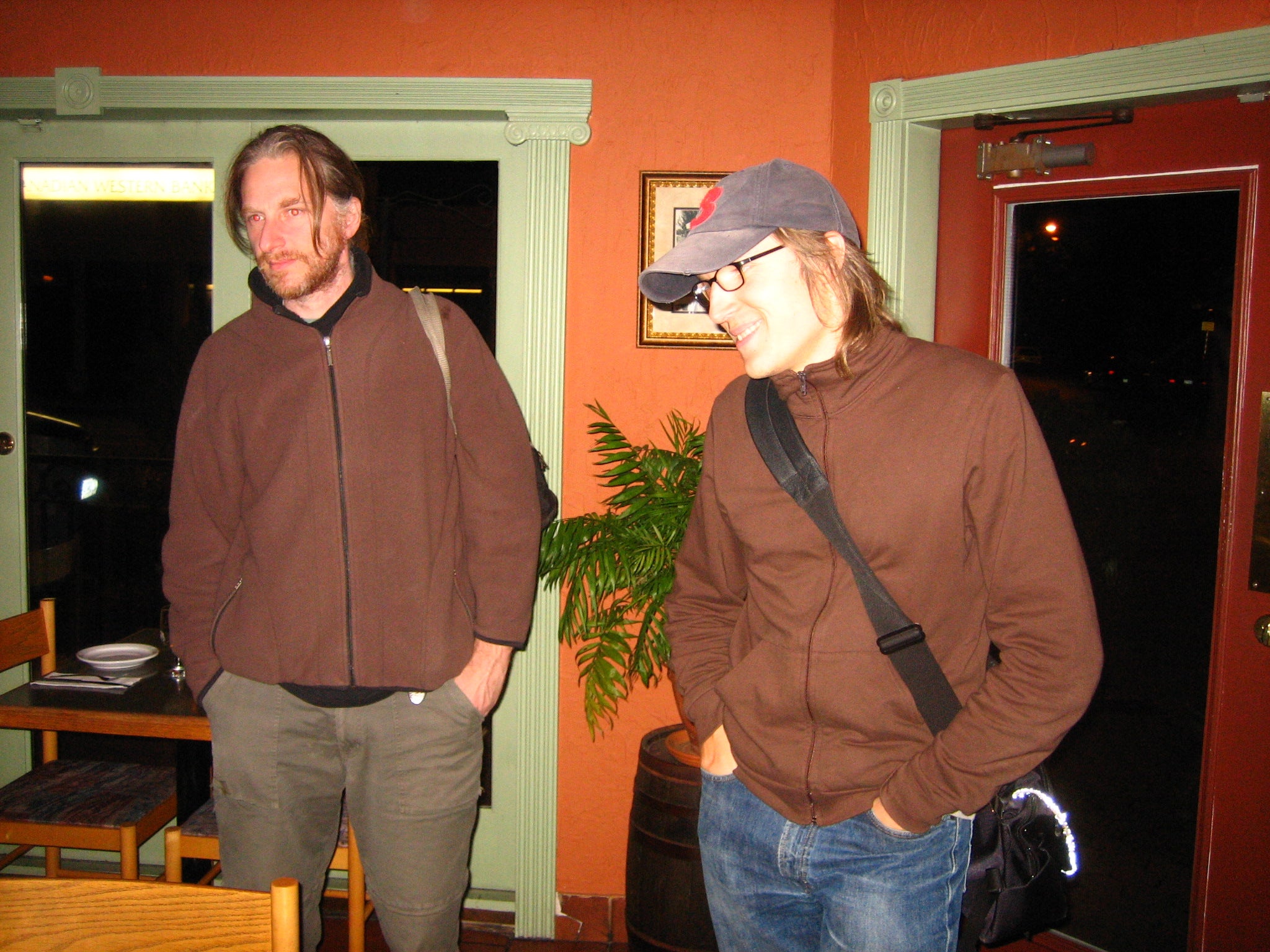 Michael and Josh standing with their hands in their pockets near the exit of a restaurant nobody seems to remember the name of, both wearing brown sweaters