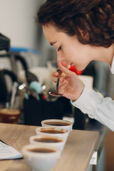 A woman cupping coffee