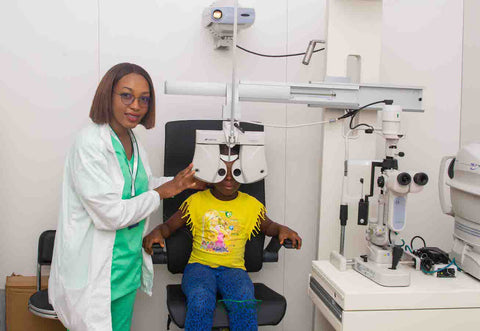 Doctor performing an eye test on a girl at SpecSMART eye clinic