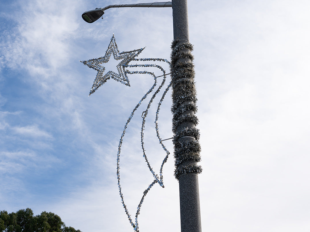 Day shot close up of Metro Pointes silver Falling Star pole mount decor.