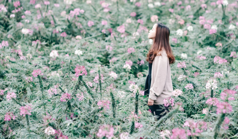 Woman Looking Out Lost Over Flower Field