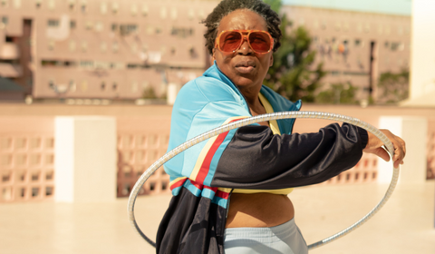 Middle Aged Black Woman In Sunglasses Doing Hula Hoop