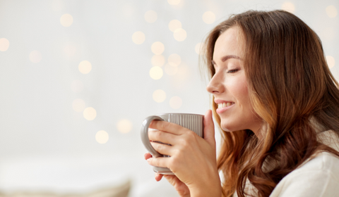 Woman Drinking Coffee And Smiling