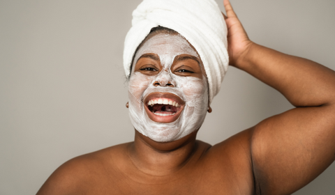 Woman with face mask on laughing