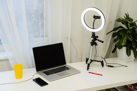 laptop with ring light on a desk