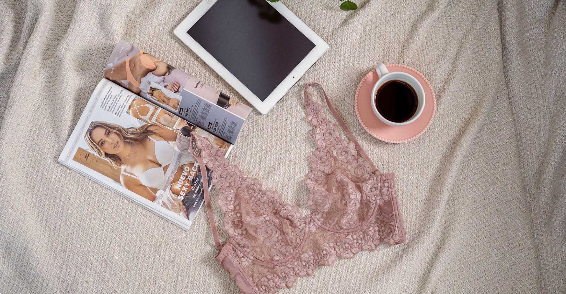 Pink lace bra on bed