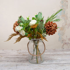 Orange Chrysanthemums and Foliage in a Large Rope Lantern Vase