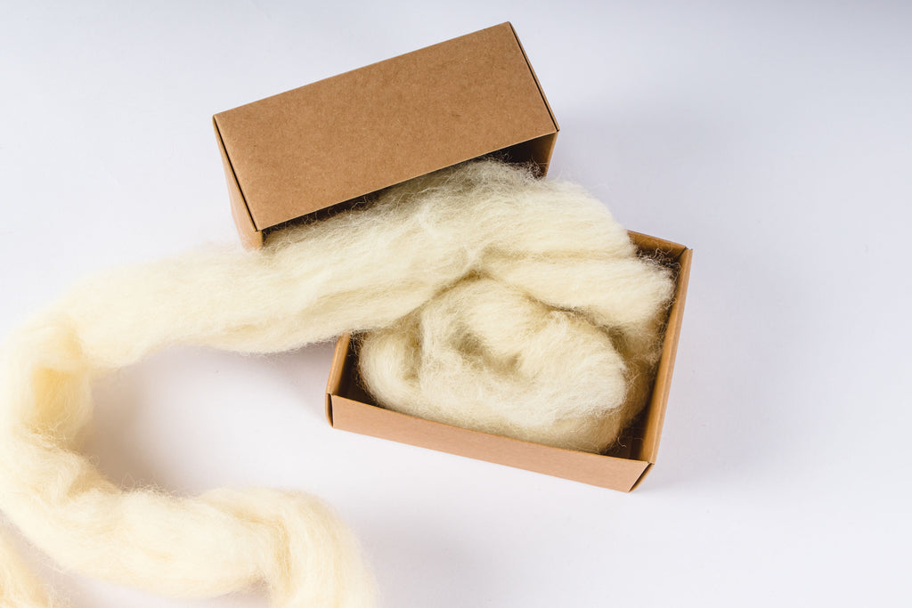 Wool filler being used to fill a box.