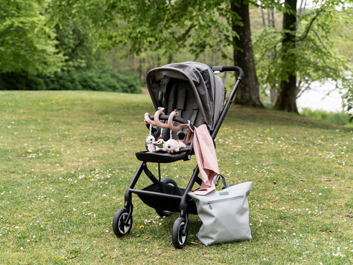 Stroller with deer friends toys in soft from Done by Deer and changing bag in grey