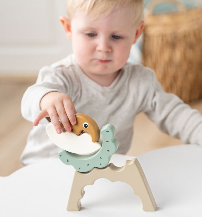 Boy playing with the Done by Deer Antee wooden puzzle