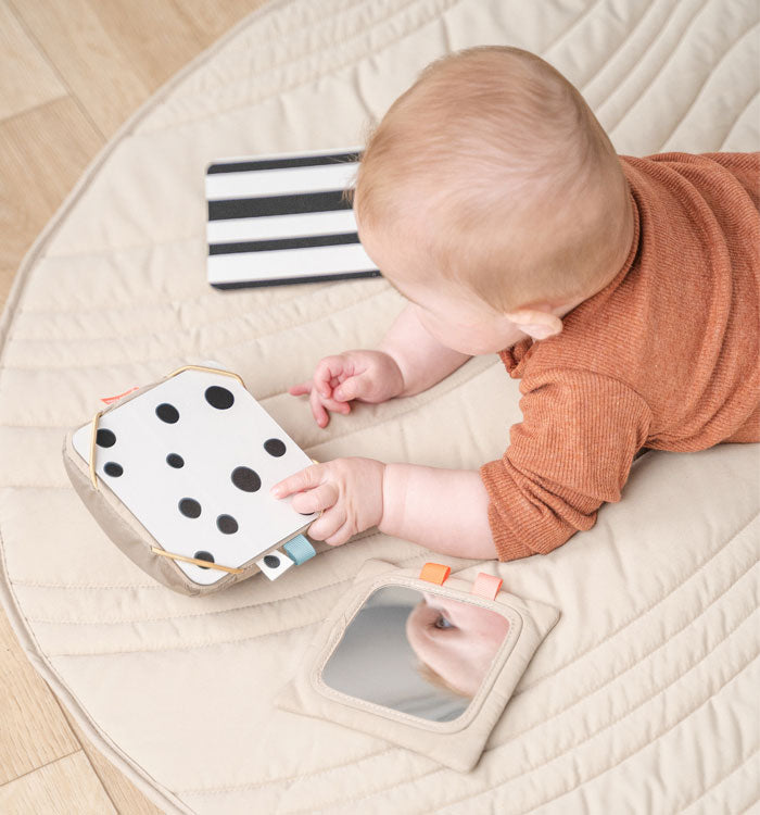 Baby looking at a card with black and white dots