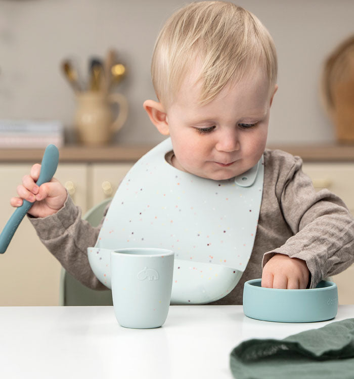 Boy eating from Done by Deer silicone tableware