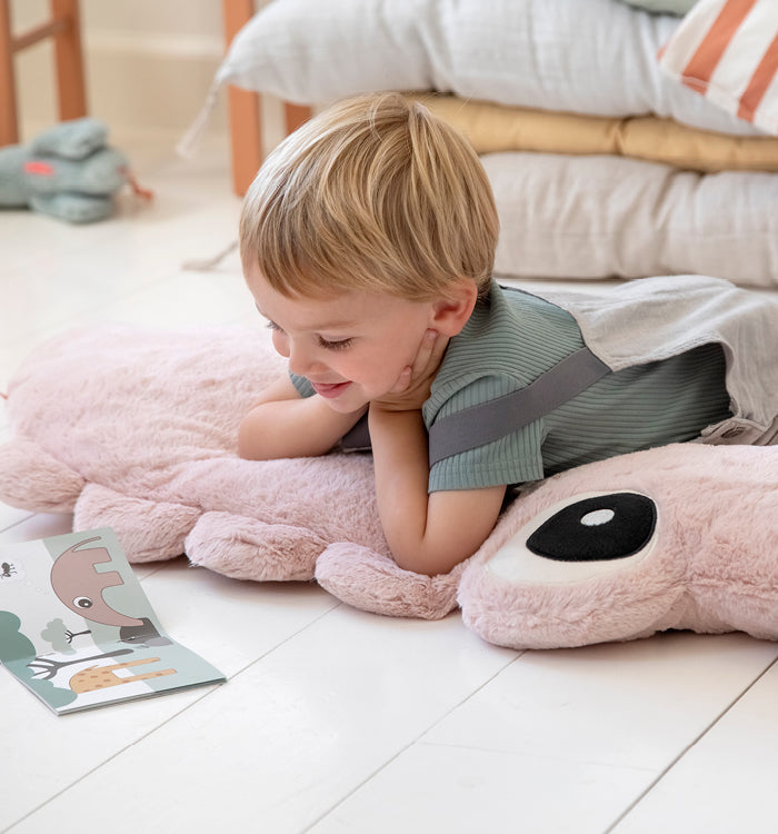 Boy reading in his room with Done by Deer