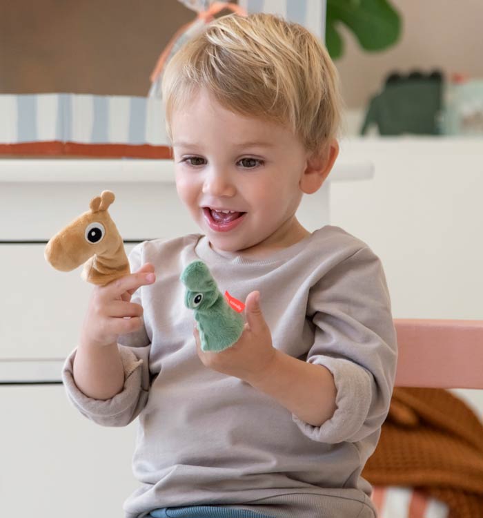 Child playing with Done by Deer finger puppets