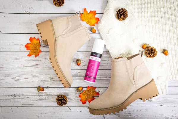 Suede ankle boots next to Foot Petals water and stain repellent spray