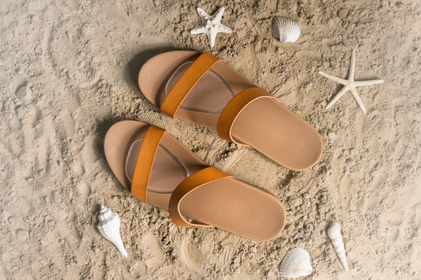 Yellow sandals on beach with Foot Petals gel ball of foot cushions inside