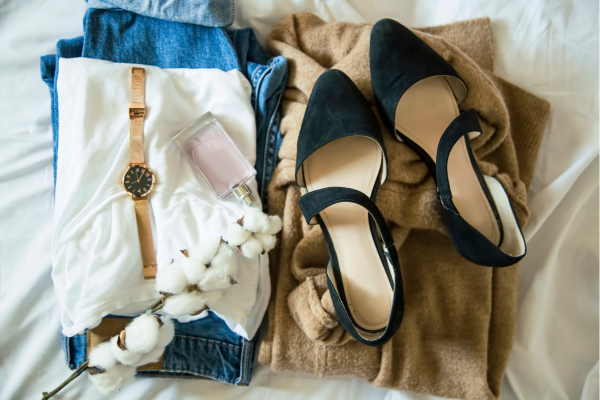 women’s black flats with folded outfit featuring jeans and white shirt