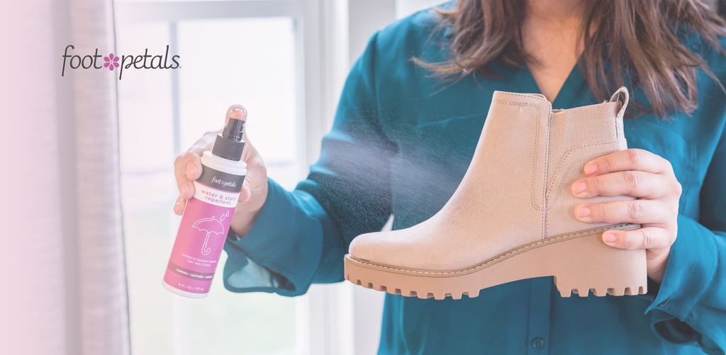 close-up of woman spraying suede boot with Foot Petals shoe protector spray