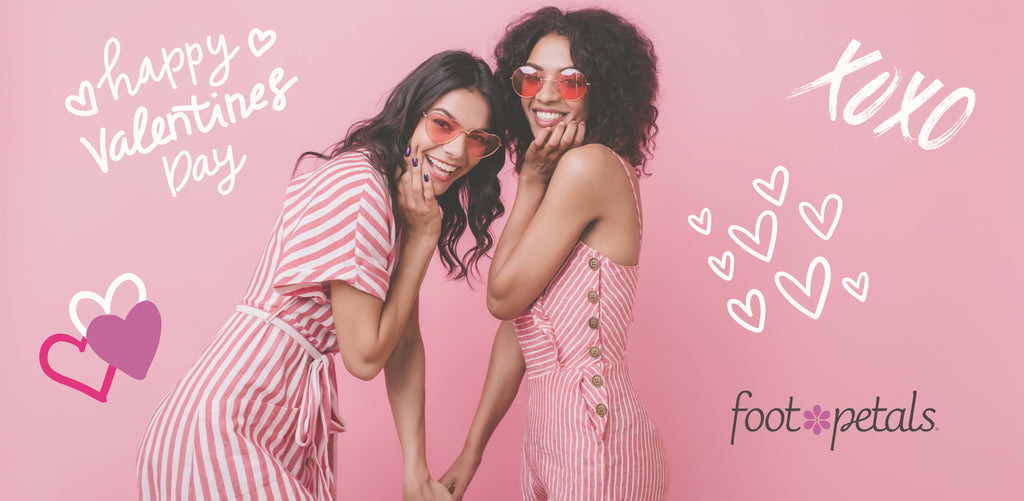Two women in pink and white striped Valentine’s Day outfits