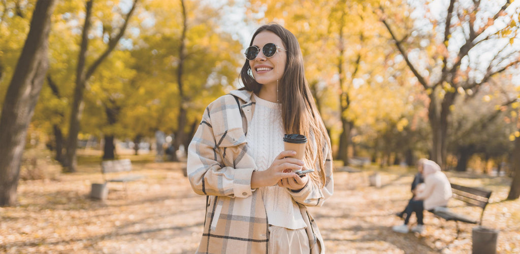 Woman walking outside during the fall time comfortably while wearing layered clothing