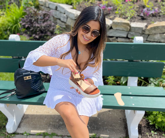 Woman placing ¾ shoe insert into sandal