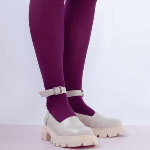 woman wearing purple tights and white Mary Janes