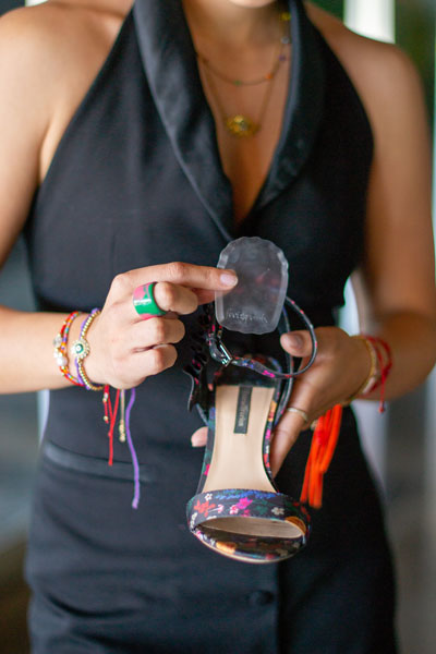 Woman placing gel heel cushion into floral chunky heel