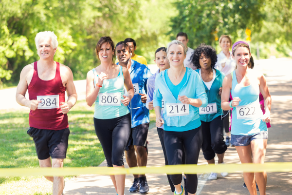 Group of people running a 5K race at the finish line