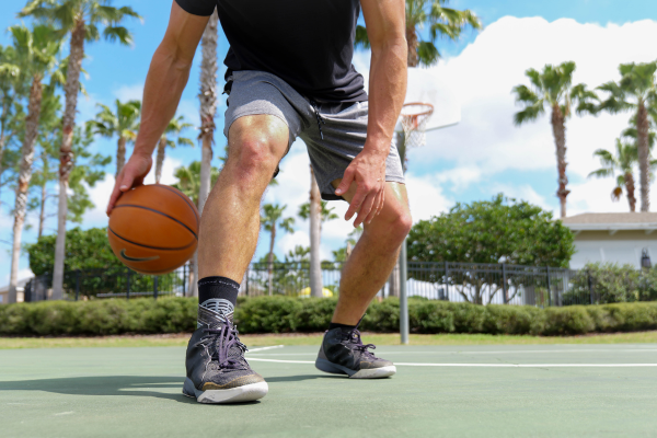 Man playing basketball wearing Dynamic Ankle Support Sock