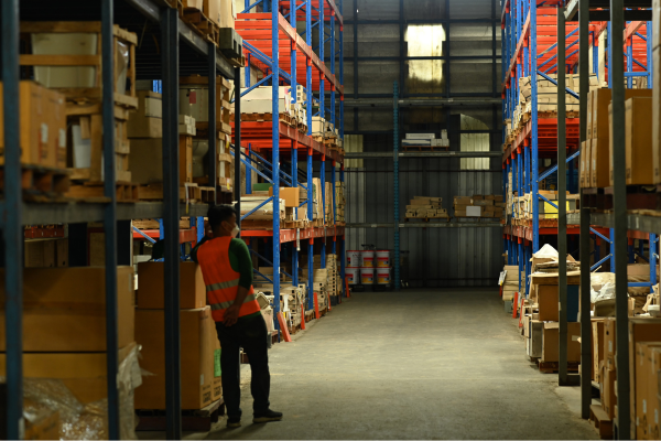 warehouse employee standing in aisle