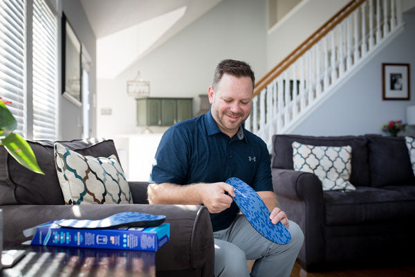 Man holding PowerStep Original Orthotic Insole