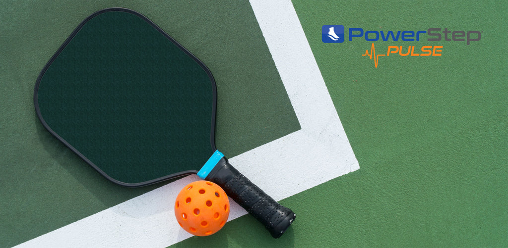 Pickleball racket and ball on pickleball court